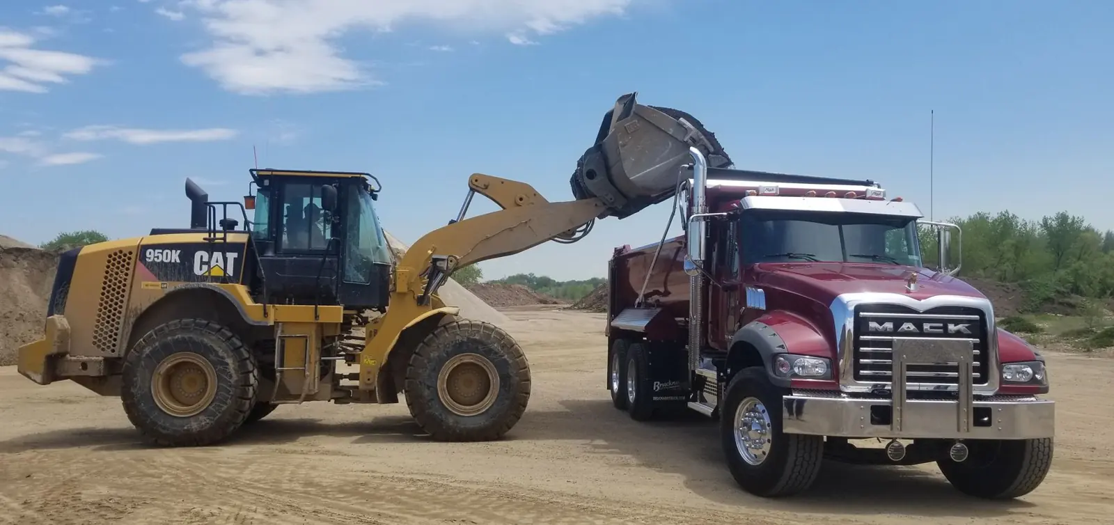 Loader filling a dump truck at Wild Bill's yard in Erie